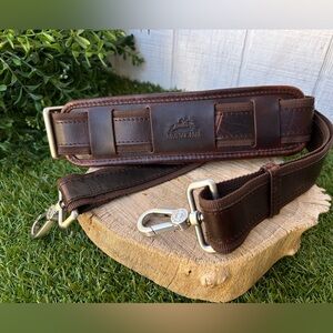 MANCINI brand leather shoulder strap designed for luggage, bags, or briefcases.